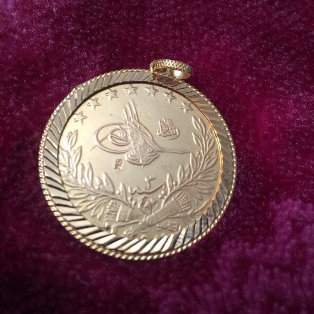 1909  golden Arabic coin with holder